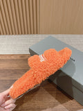 FURRY SLIDES IN ORANGE CURLY SHEARLING
