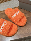 FURRY SLIDES IN ORANGE CURLY SHEARLING
