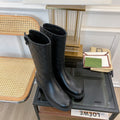 GG EMBOSSED LEATHER ANKLE BOOTS IN BLACK CALFSKIN