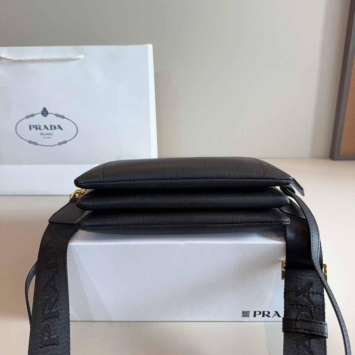 EMBOSSED LOGO HOBO SHOULDER BAG 23 IN BLACK SHINY SAFFIANO LEATHER