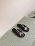 FLAT MULES IN BLACK SMOOTH CALFSKIN GOLD BUCKLE