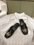 FLAT MULES IN BLACK SMOOTH CALFSKIN GOLD BUCKLE
