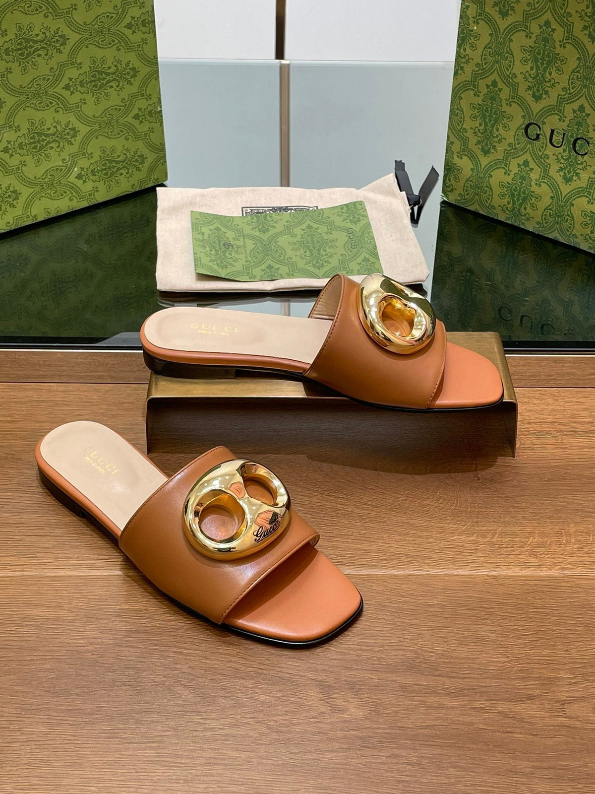 FLAT MULE IN BRONE BROWN CALFSKIN WITH GOLD HARDWARE