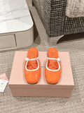 FLAT MULE IN VIVID ORANGE PATENT CALFSKIN