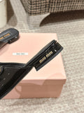 FLAT MULE IN BLACK PATENT CALFSKIN