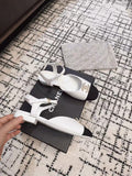 FLAT SLINGBACKS IN WHITE CALFSKIN AND BLACK FABRIC